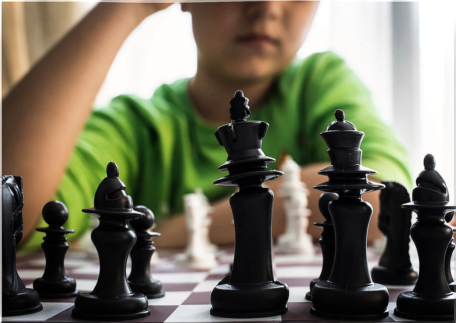 Genius boy playing chess.