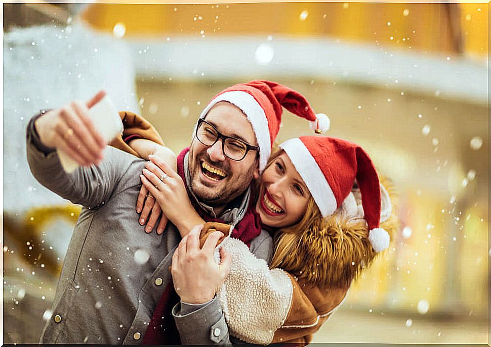 Couple taking a Christmas selfie.