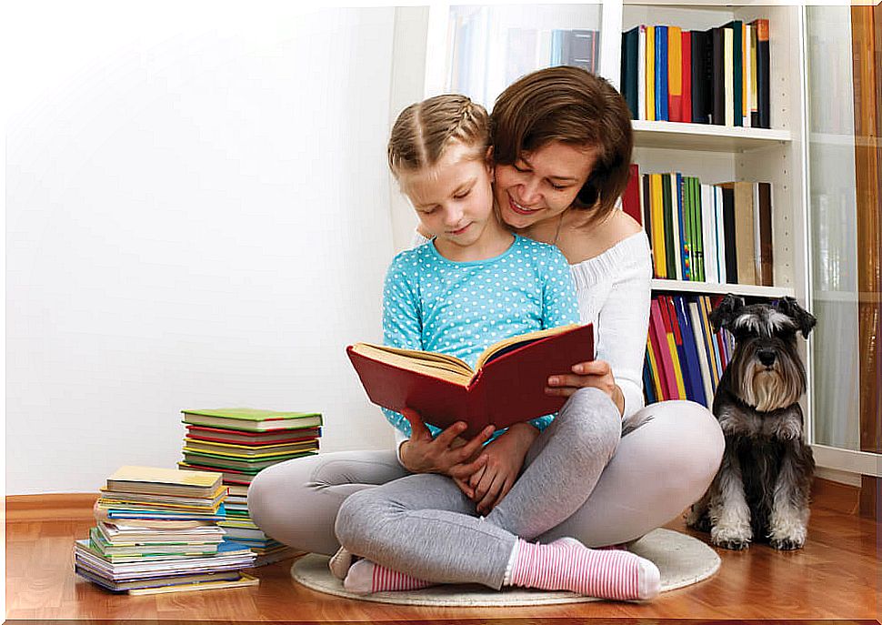 Mother and daughter reading books in their home library to encourage reading.