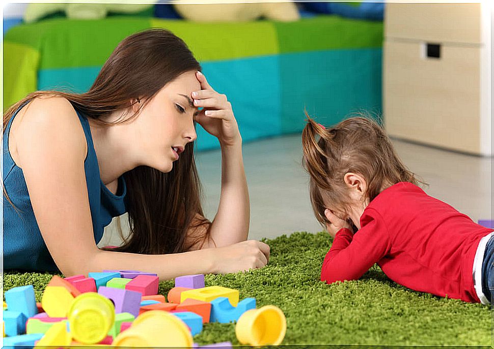 Frustrated mother trying to follow the advice not to spoil the children too much.