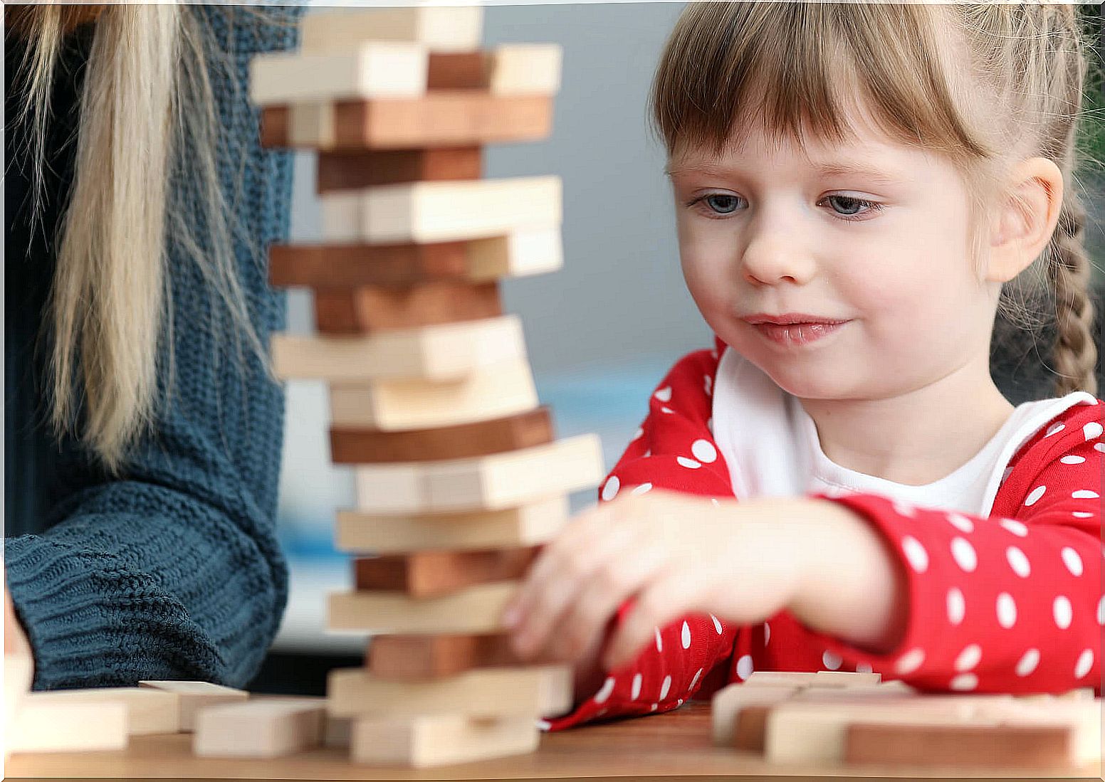 Girl playing Jenga.