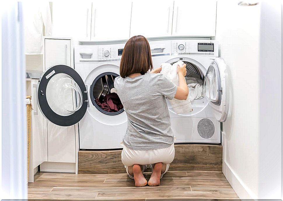 Woman putting washing machines.