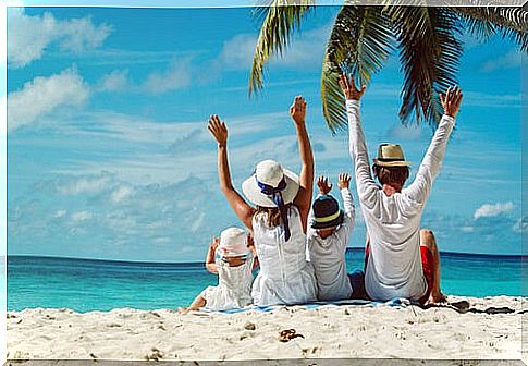 Parents with their children on the beach enjoying the vacation