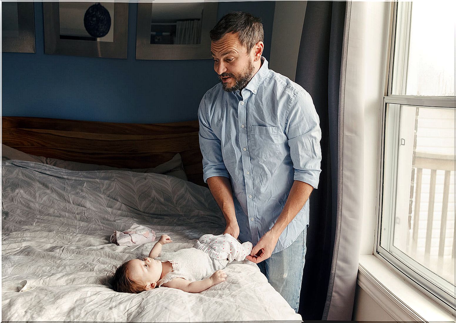 Father learning how to change the baby's diaper.