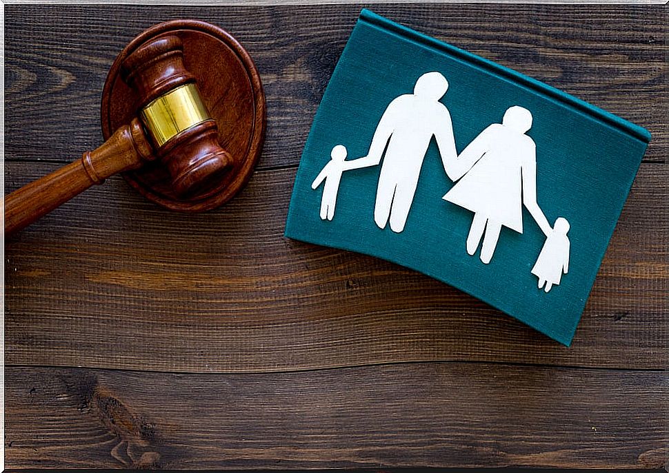 A gavel and a drawing of a family representing family trials.