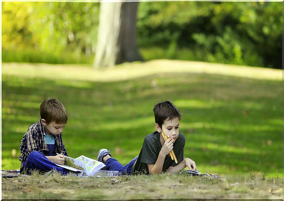 Children reading children's books to value friendship in the park.