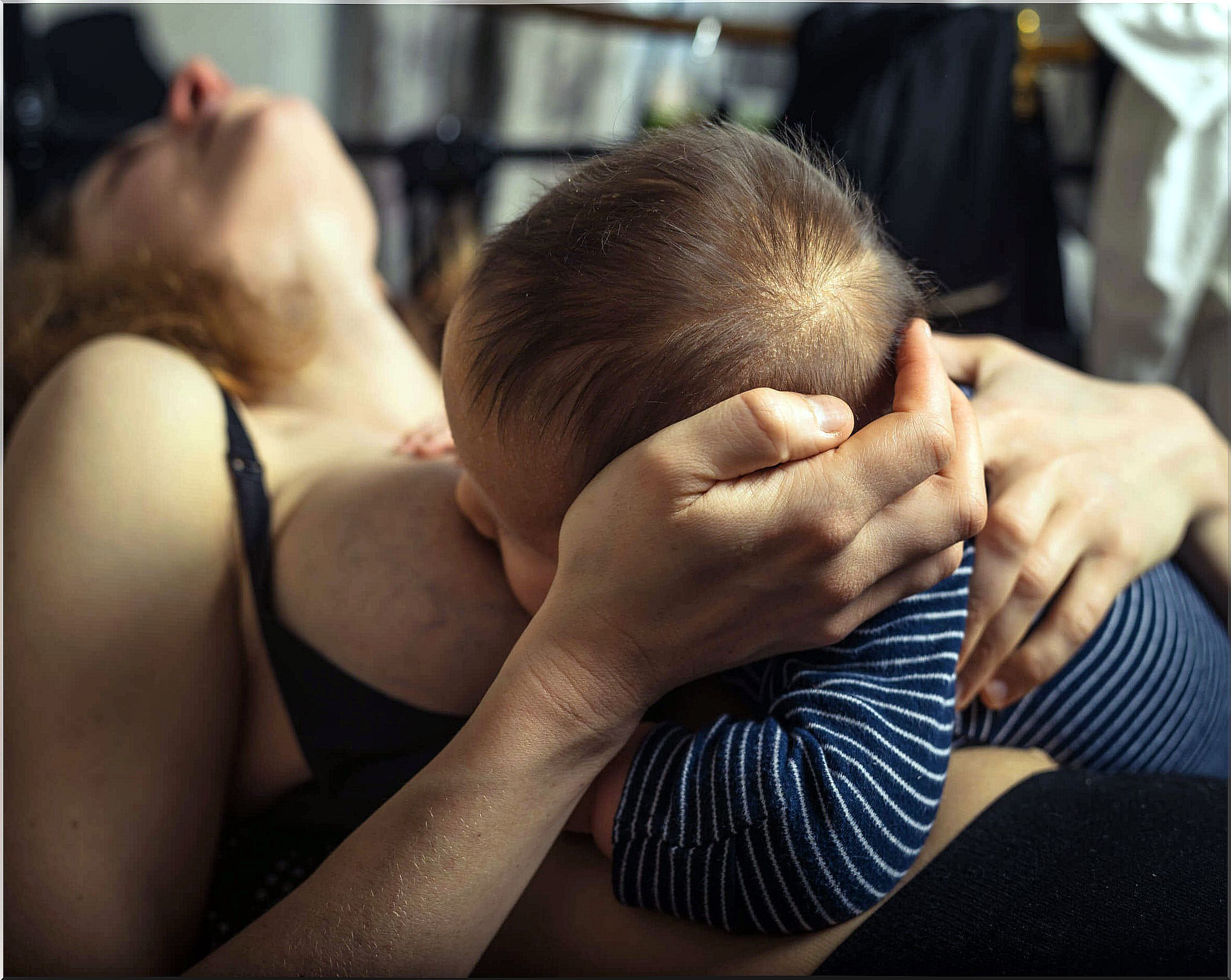 Woman with sore nipples during breastfeeding.