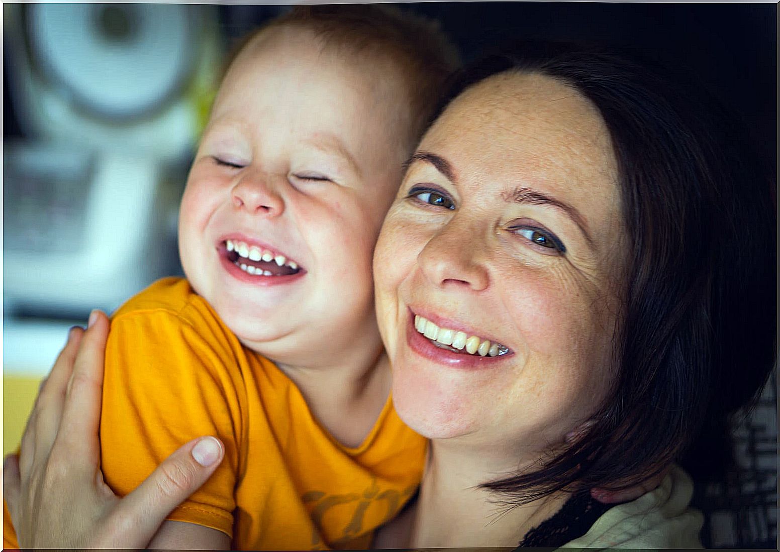 Mom smiling next to her son.