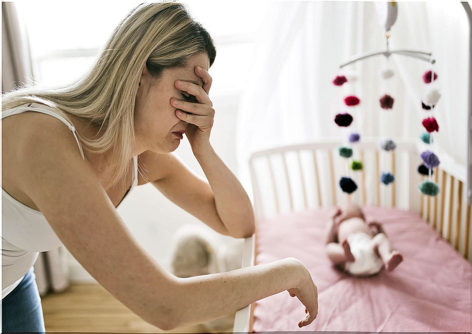 Mother crying because she suffers from postpartum depression and rejection of her child.