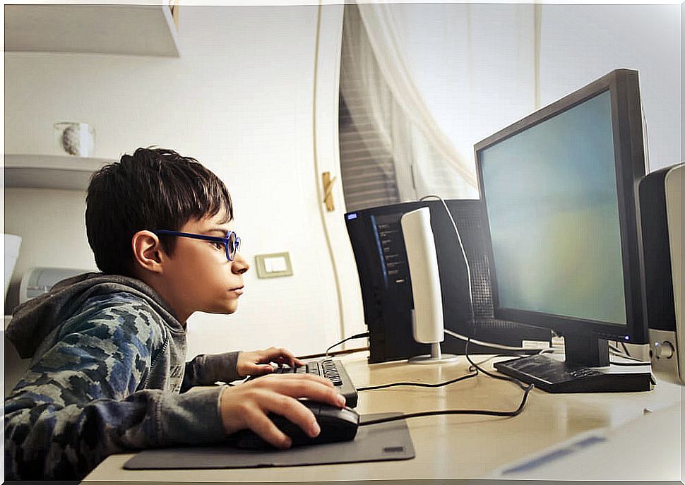 Child addicted to video games with a computer.