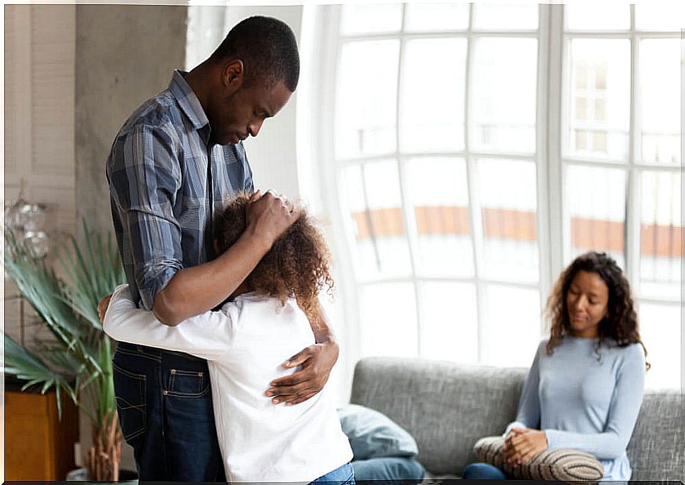 Little girl hugging her divorced father from her mother.