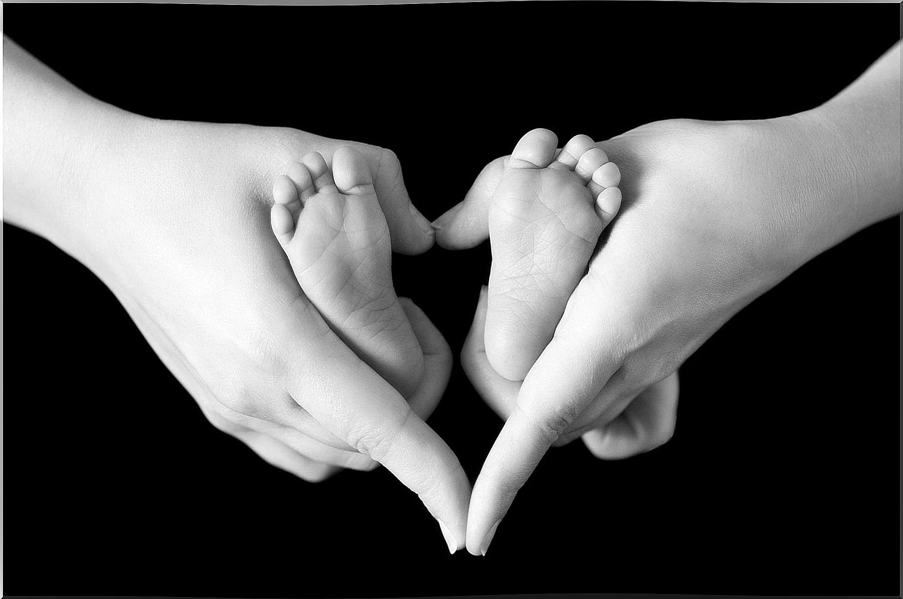 Mother holding her baby's feet