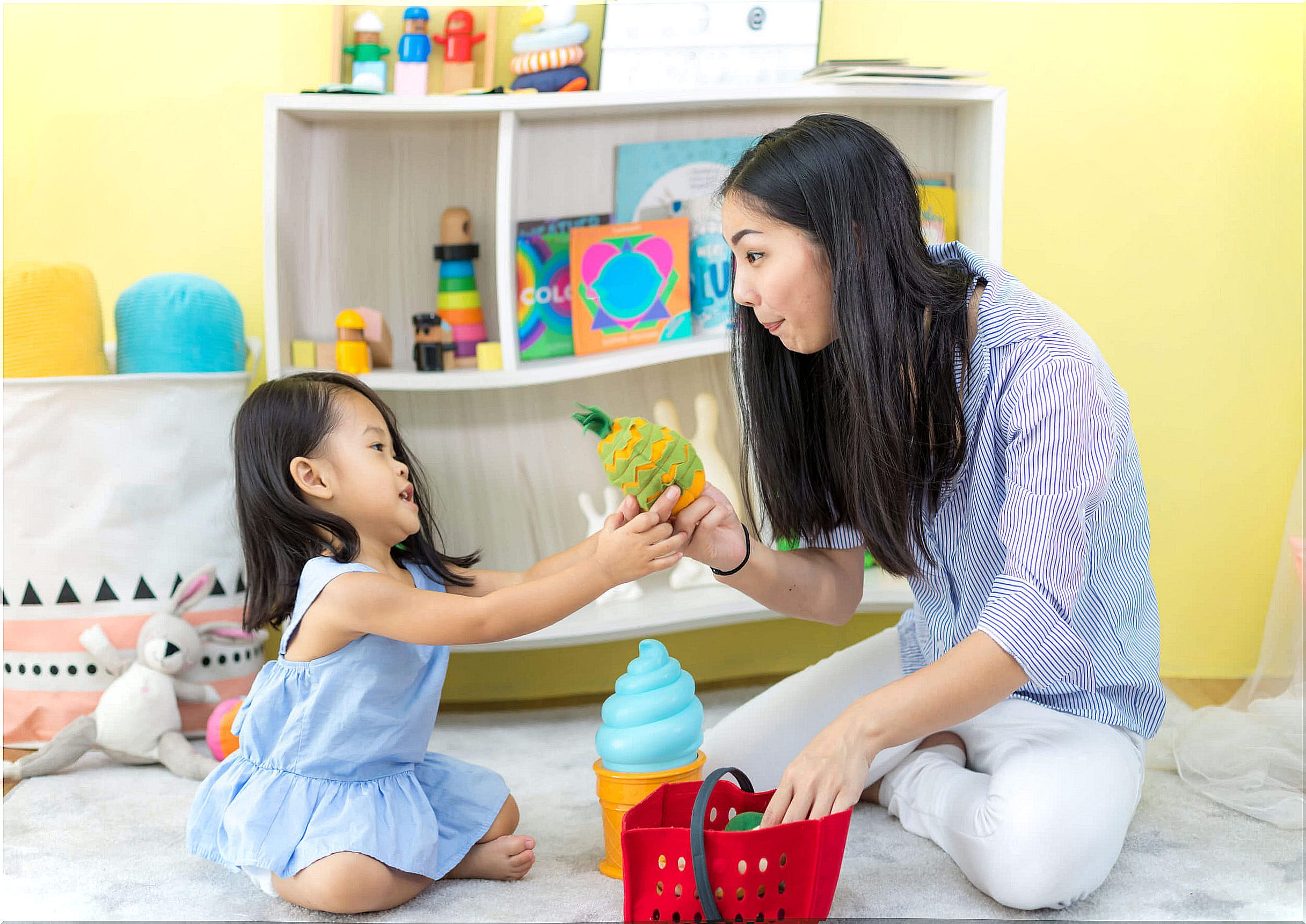 Mother playing with her daughter to stimulate her language at home.