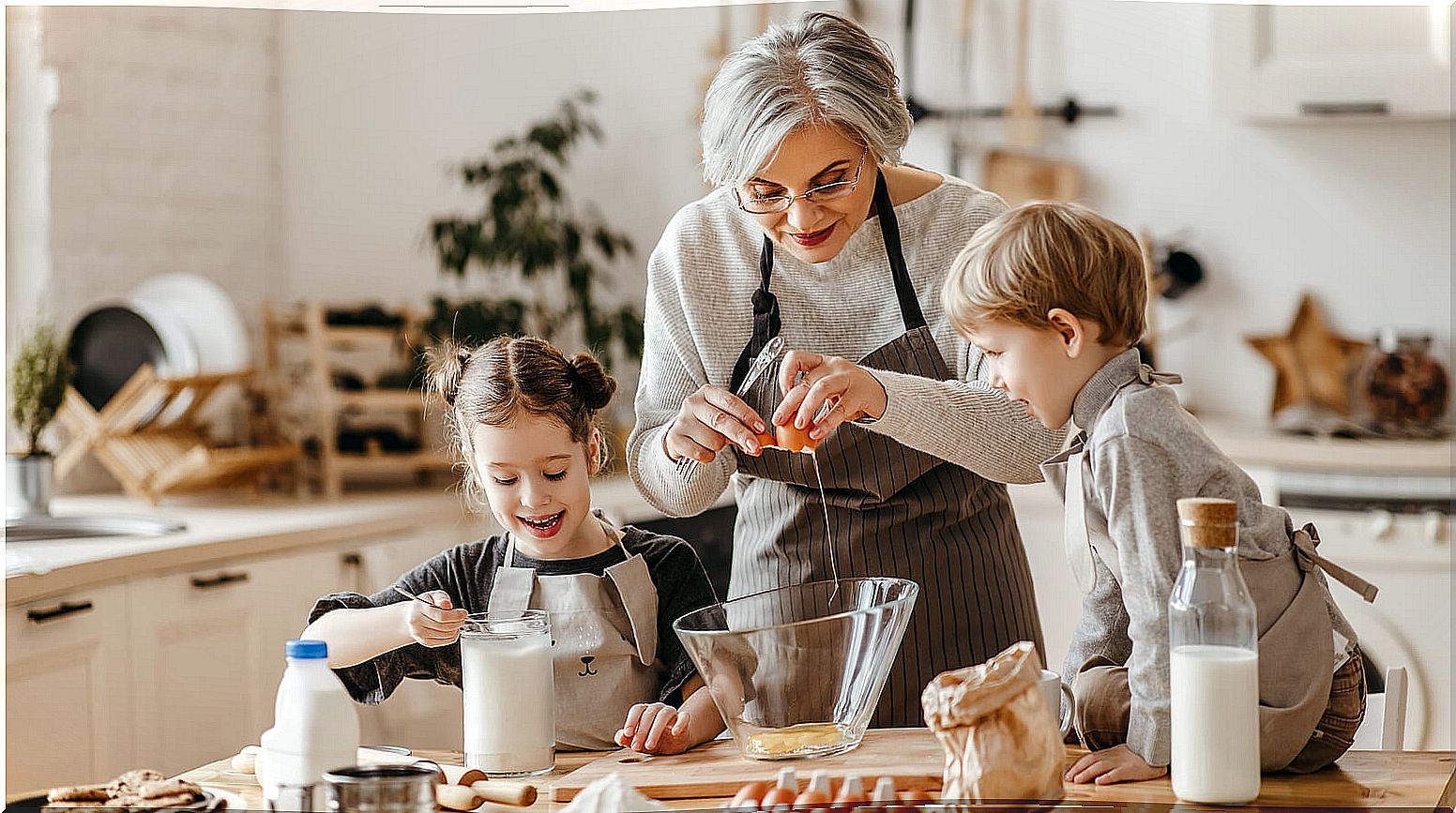 Grandmother cooking pastry recipes with her grandchildren.