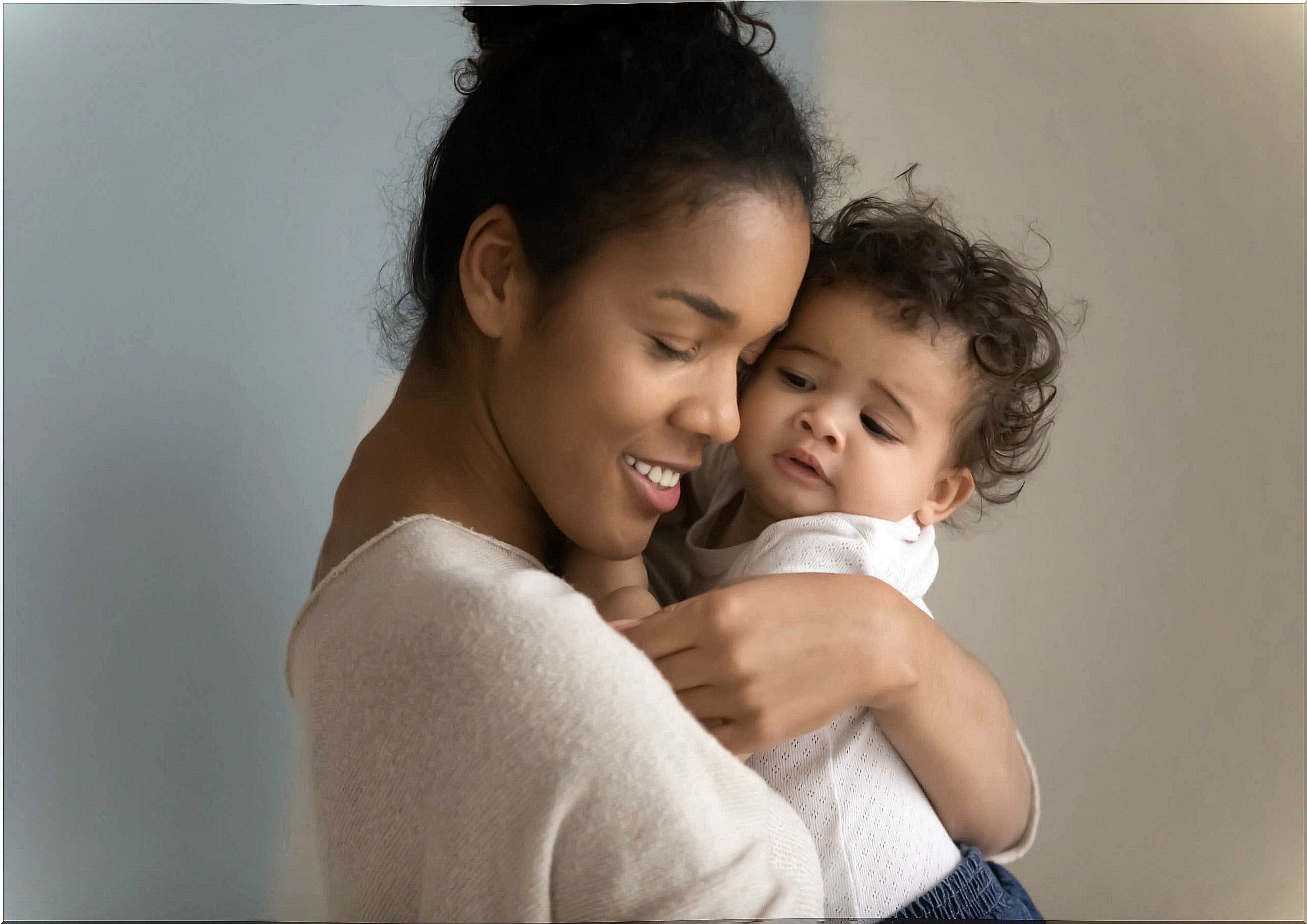 Mother giving a hug to her high demand baby.