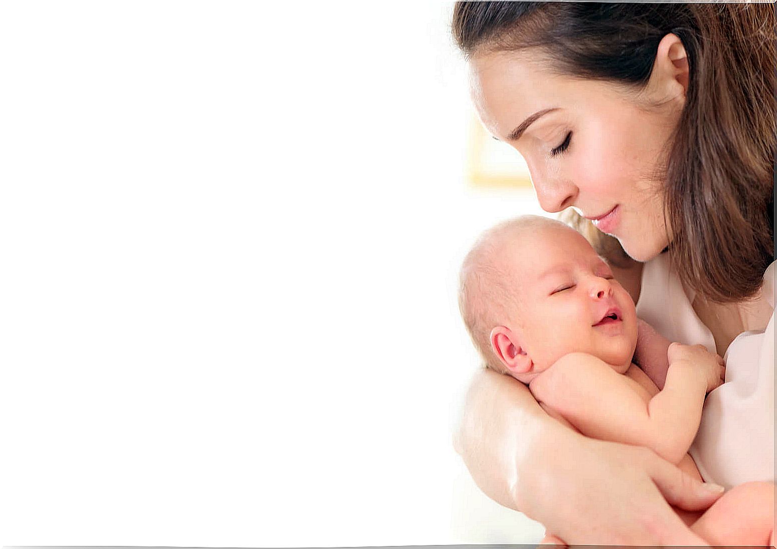 Mother giving a kiss to her newborn son before leaving the hospital.