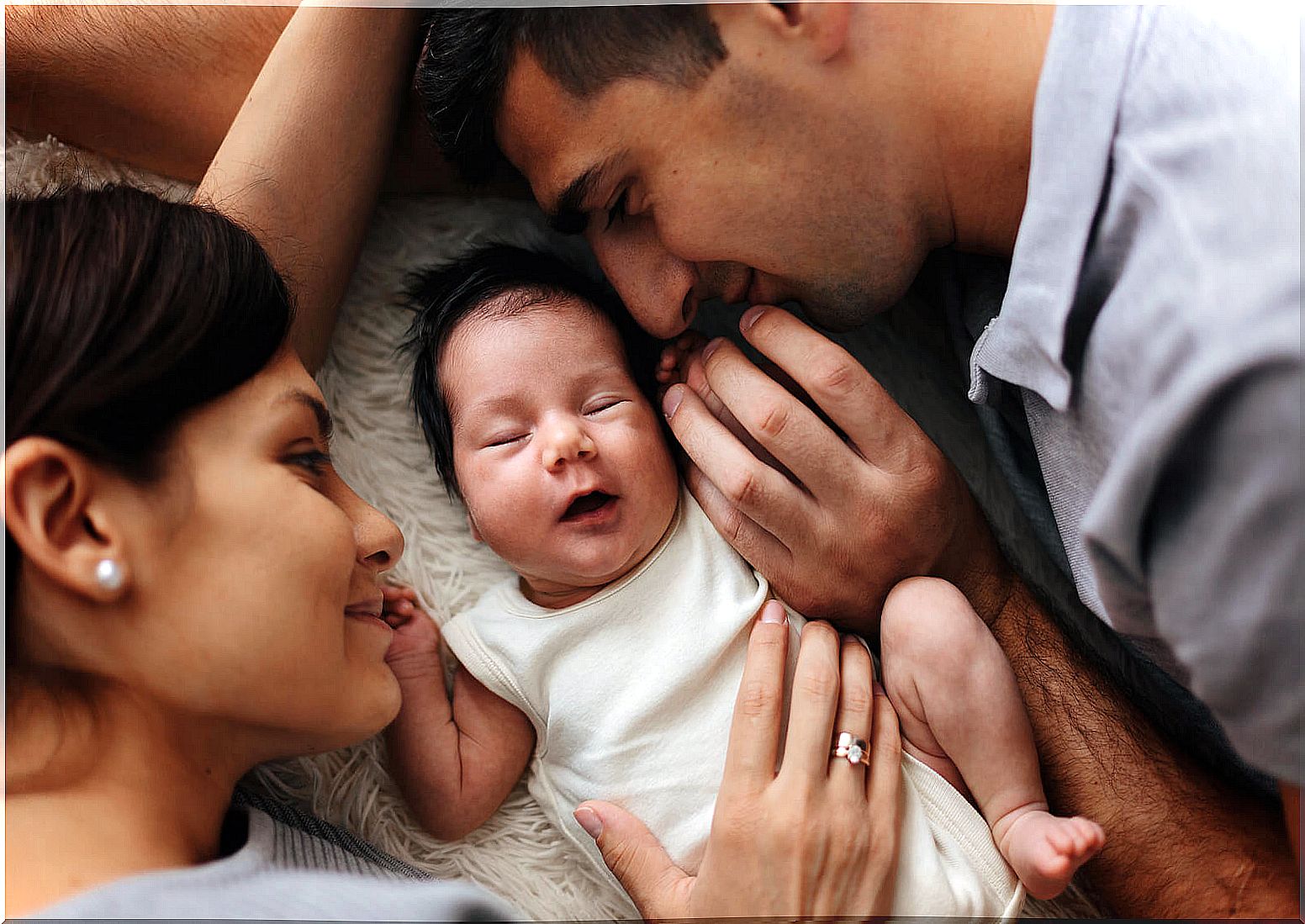 Happy parents leaving the hospital with their newborn son.